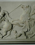 photo of plaster cast relief of men, some with armor, horses, and a dog on a tan-colored wall