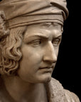 photo of plaster cast sculpture bust of man, namely Christopher Columbus, in robes and hat with black background