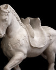 Photo of a sculpture of a plaster horse on a black background