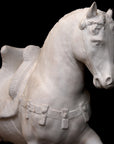 Photo of a sculpture of a plaster horse on a black background