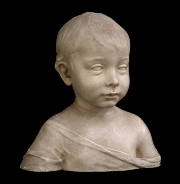 photo of plaster cast sculpture of boy from shoulders up with light tunic slipping off left shoulder with black background