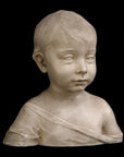 photo of plaster cast sculpture of boy from shoulders up with light tunic slipping off left shoulder with black background