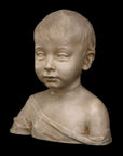 photo of plaster cast sculpture of boy from shoulders up with light tunic slipping off left shoulder with black background