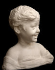 photo of white plaster cast sculpture bust of boy with open mouth, laughing, short hair, and clothes below his shoulders against a black background