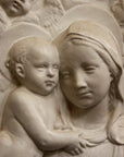 photo closeup of plaster cast relief of Madonna holding the Baby Jesus