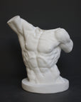 photo with gray background of plaster cast sculpture of male torso, namely Laocoon