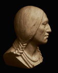 photo with black background of plaster cast sculpture of male head of Massasoit with braids and necklaces