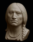 photo with black background of plaster cast sculpture of male head of Massasoit with braids and necklaces